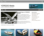 Screenshot of a website homepage titled YORGOO Media featuring a navigation bar a main welcome article with a seagull photo a sidebar with recent articles and images of boats on water below the main section
